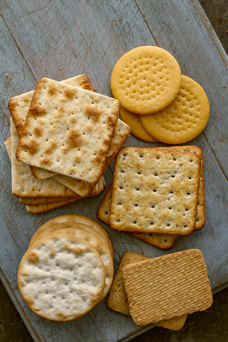 assorted-crackers-on-a-gray-wooden-board assorted-crackers-on-a-gray-wooden-board