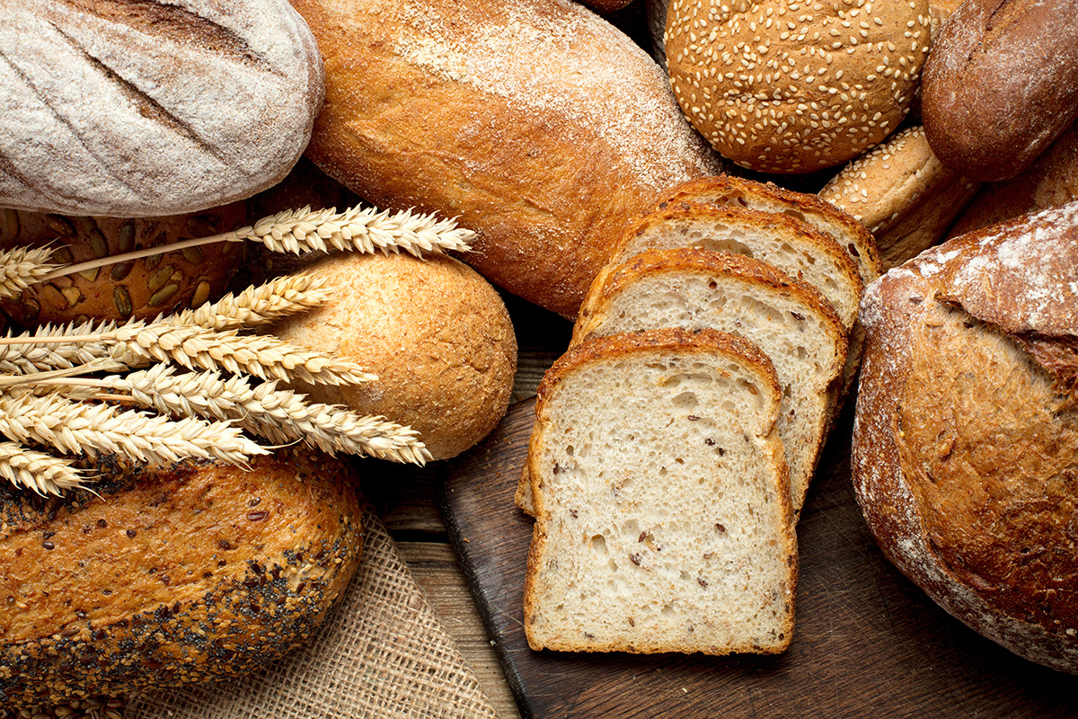 assortment-of-breads-and-grain-on-wooden-surface assortment-of-breads-and-grain-on-wooden-surface