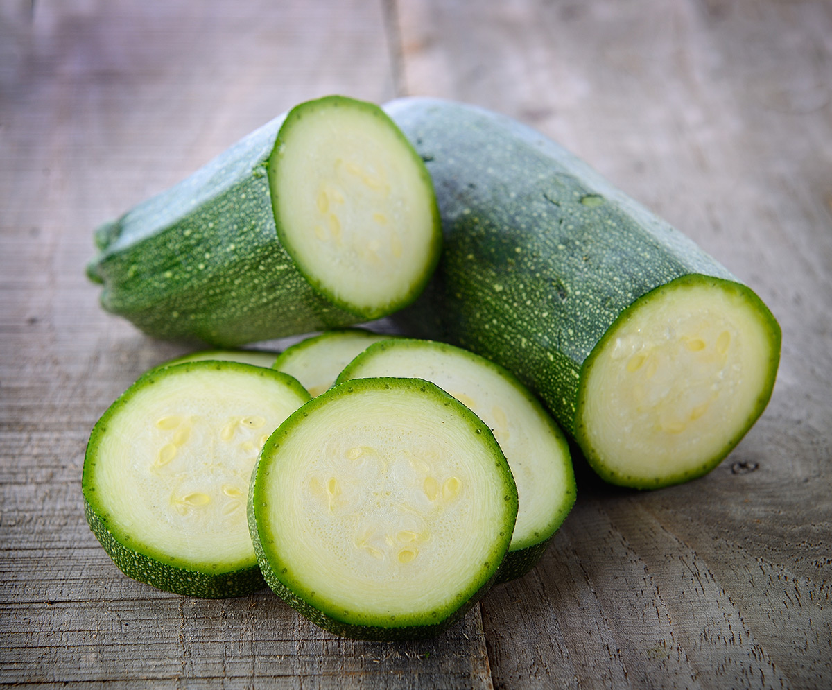 fresh-green-zucchini-slices-on-wooden-surface